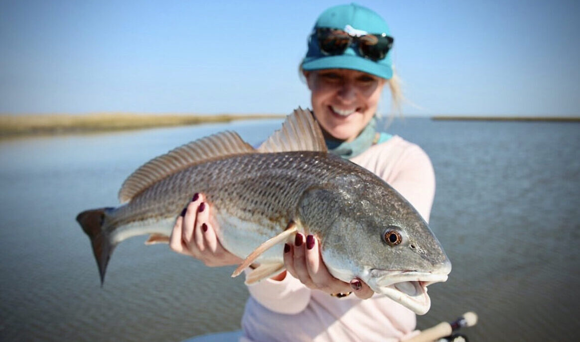 An angler with a redfish