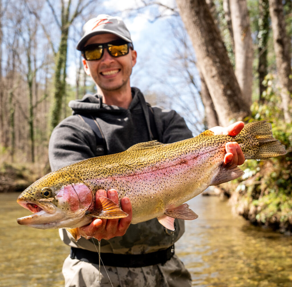 Angler holds trout hooked with Z-Man Micro WormZ